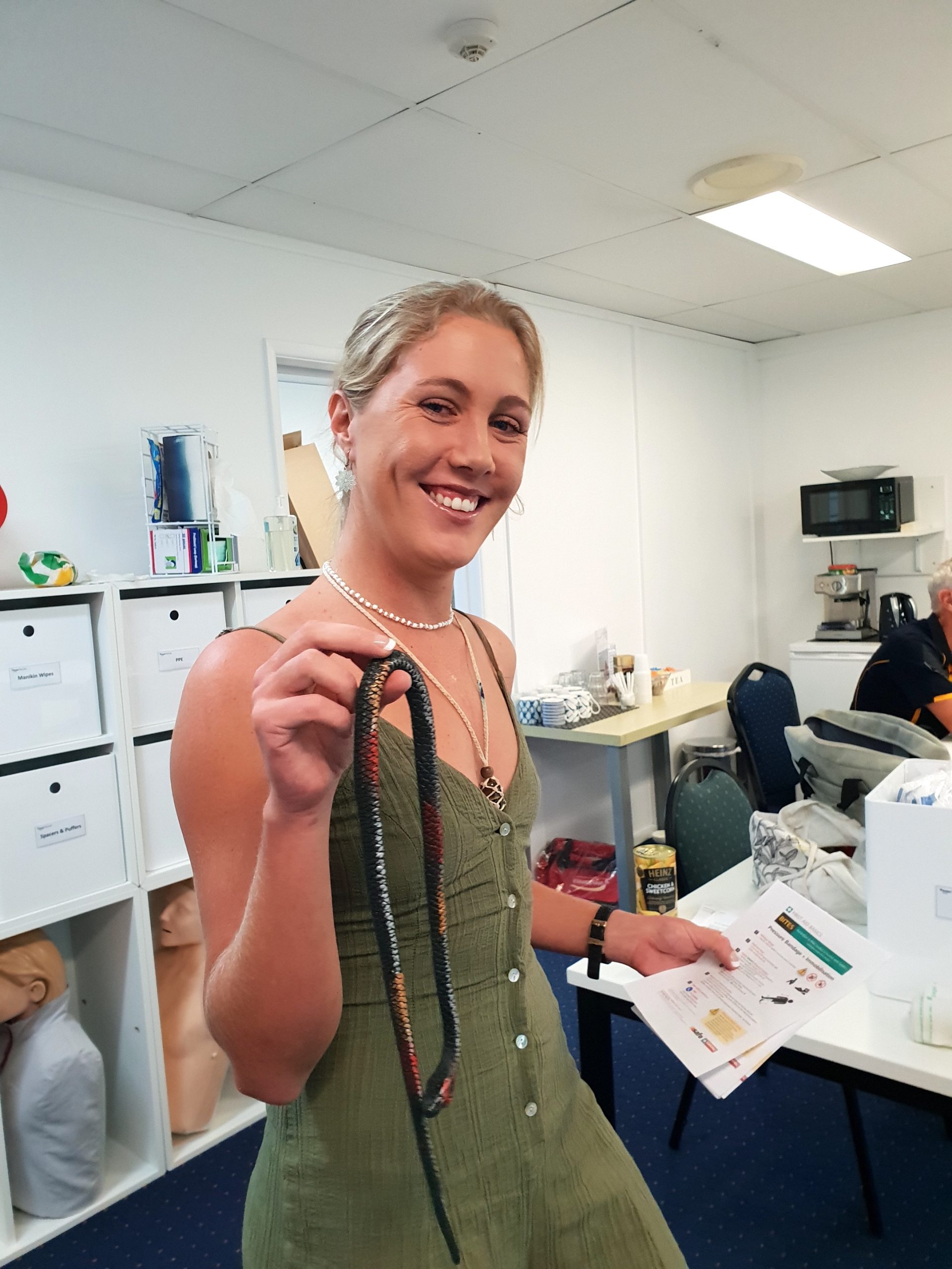 Assist Medics snake course. Woman holding fake snake
